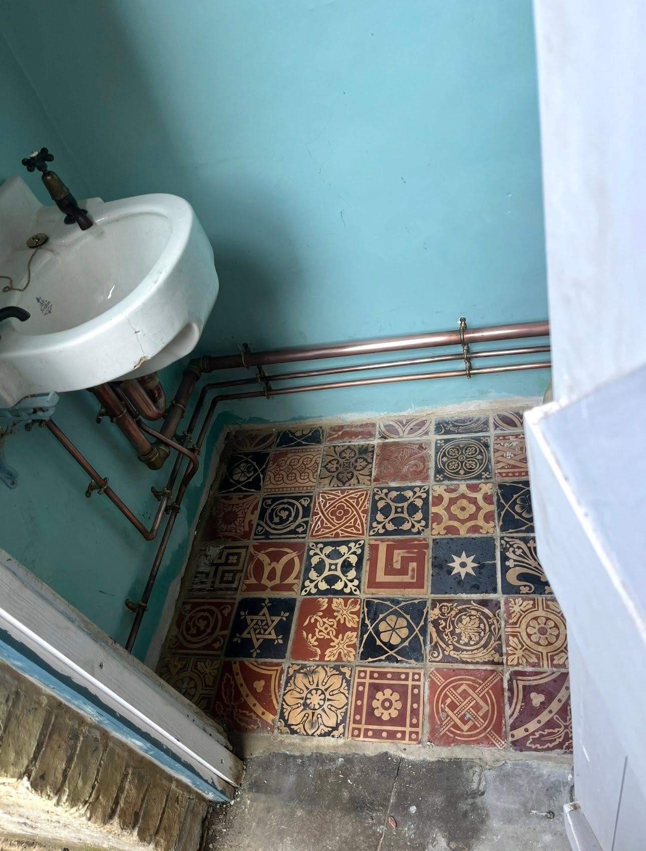 Restored pre-loved Victorian basin re-plumbed in copper over original tiled floor