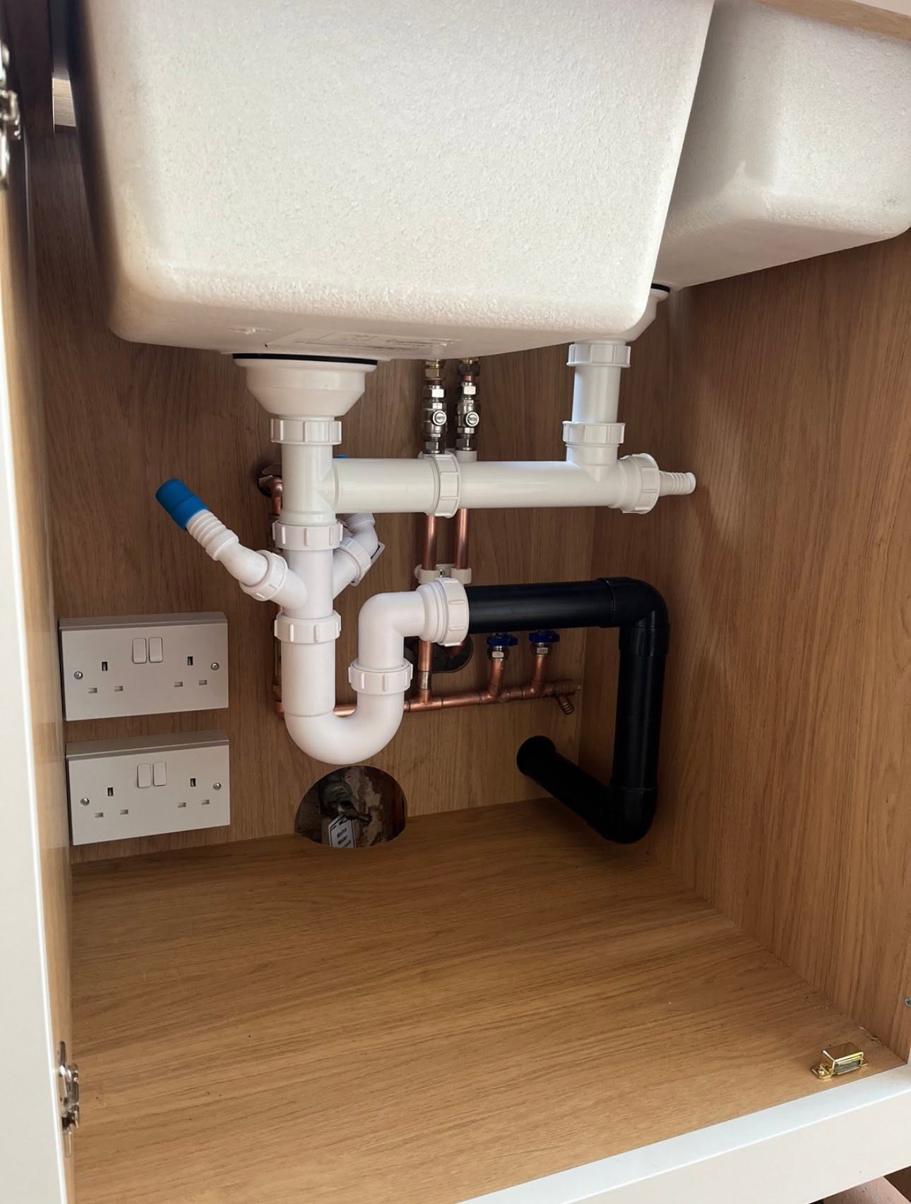 Tidy kitchen sink second fix waste and isolation valves under a new unit
