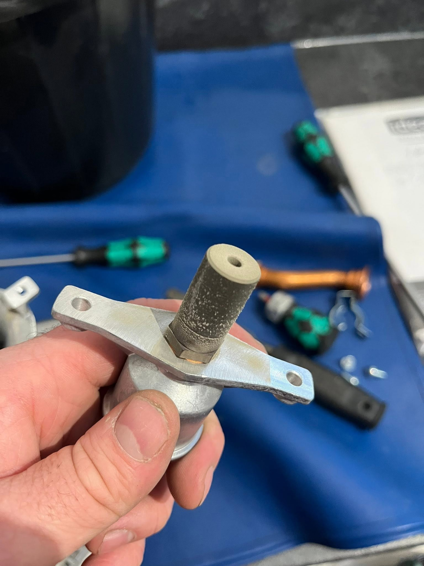 Gas Safe engineer cleaning a boiler injector during a service